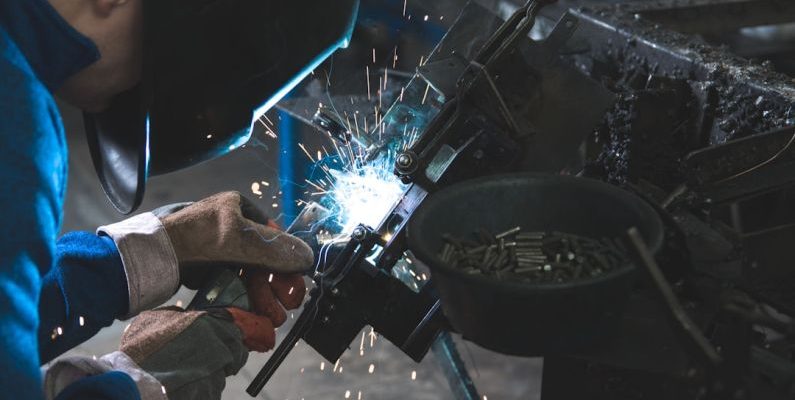 Metal Fabrication - man welding a black metal