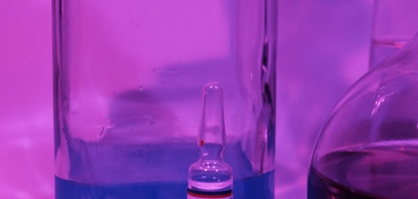 Ultraviolet Disinfection - Glass flasks with liquid near vaccine for COVID 19