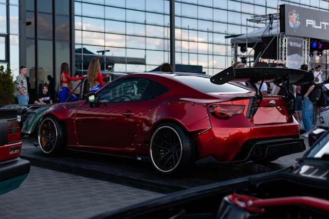 a-red-sports-car-parked-in-front-of-a-building